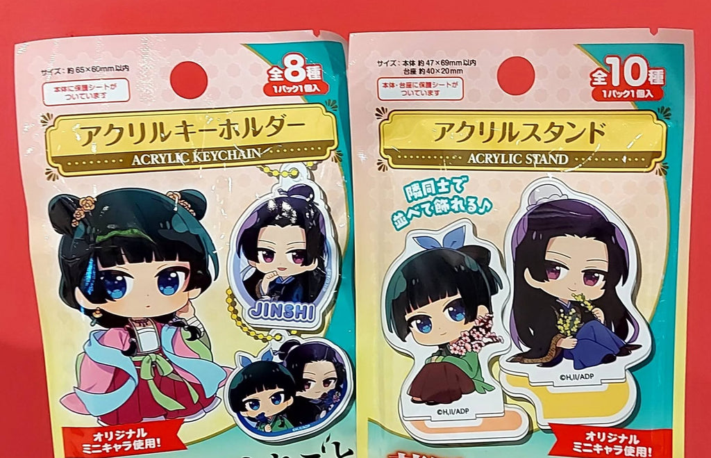 Two packages of acrylic stands with character figures on a red background