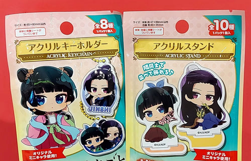 Two packages of acrylic stands with character figures on a red background